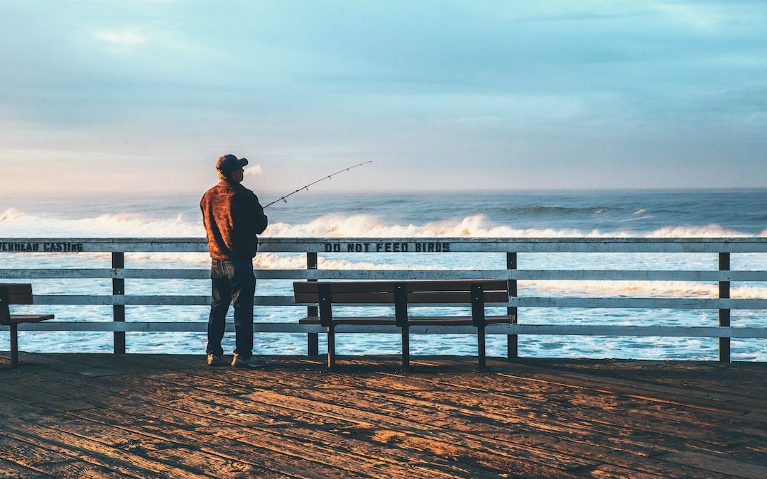 man fishing on seaside