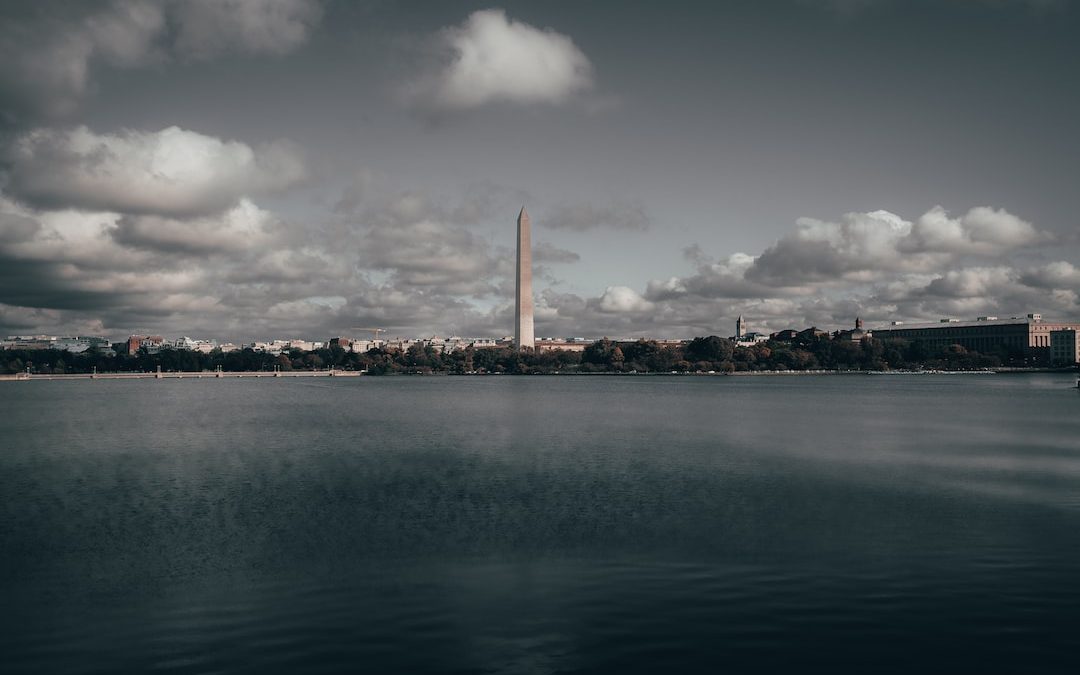 a large body of water with a tall building in the background