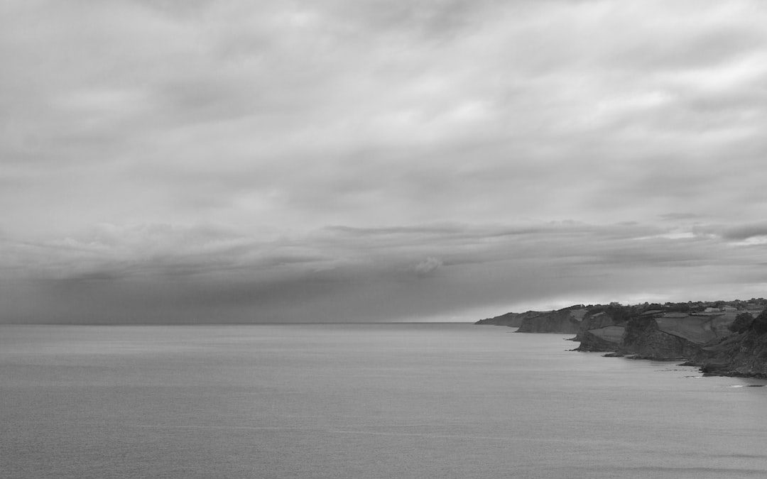 calm sea under gray clouds