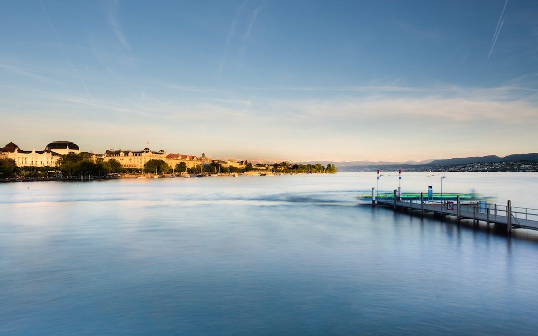 photography of buildings beside body of water during daytime