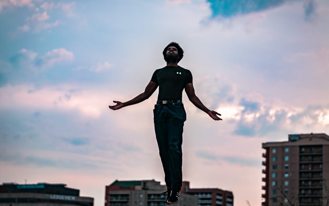 man floating near grass during daytime