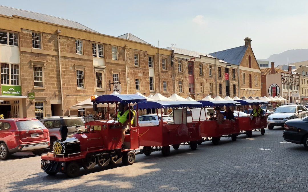 red and white train on road during daytime