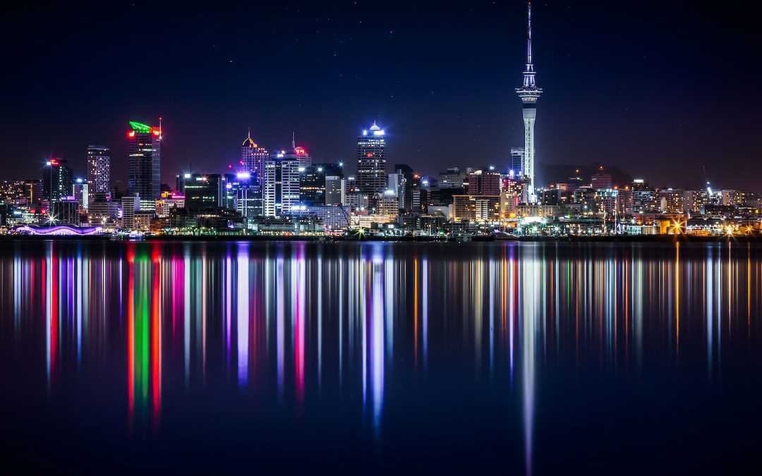 city buildings next to sea water during night