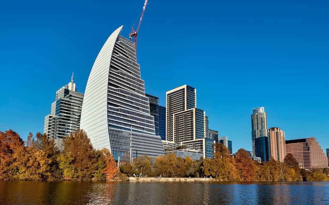 a view of a city with a lake in front of it