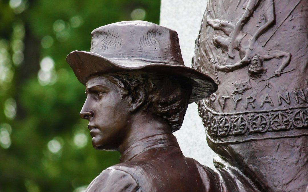 a close up of a statue of a man wearing a hat