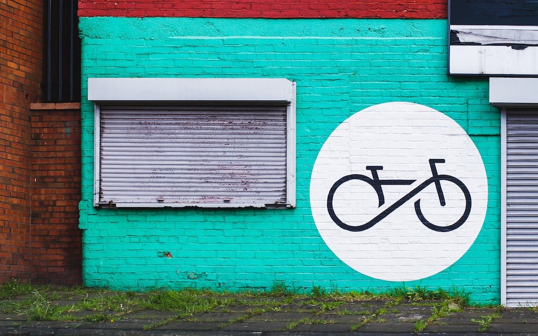 white and teal concrete house with graffiti