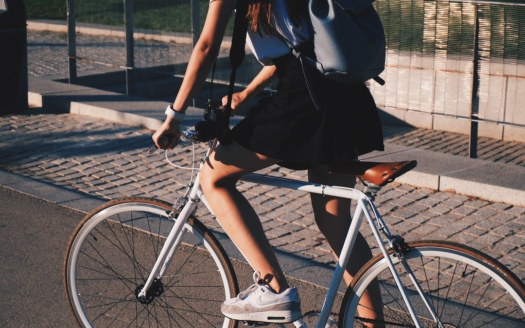 woman riding white rigid bike