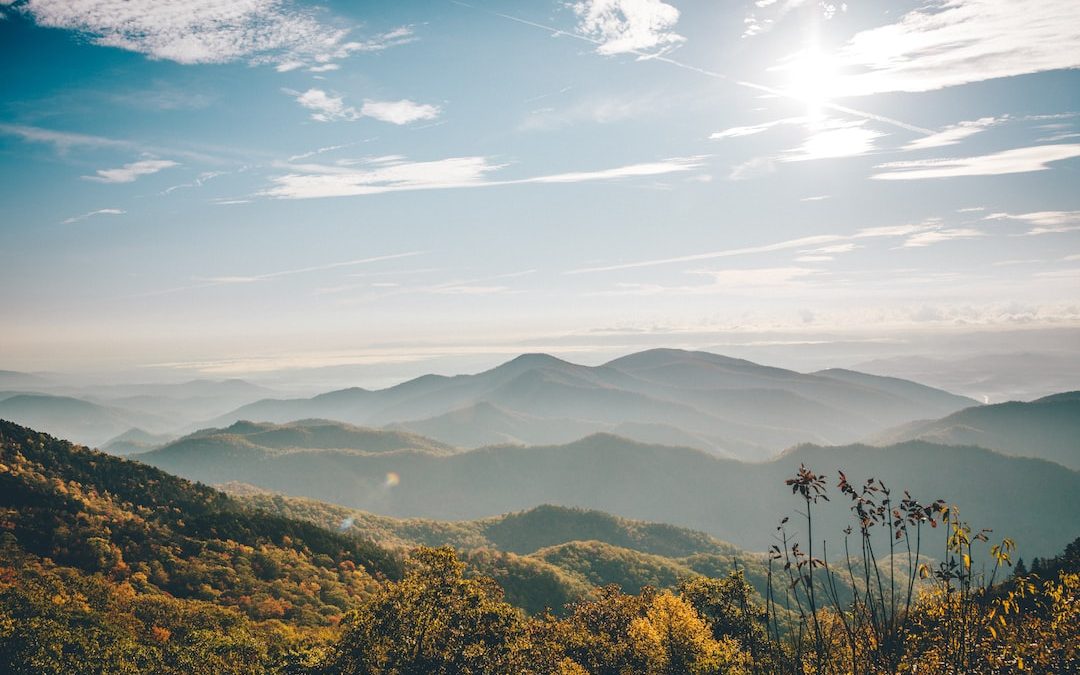 aerial photography of mountain under blue and white sky