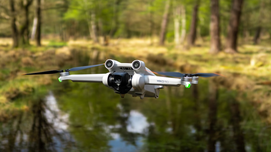 a white and black remote control flying over a forest