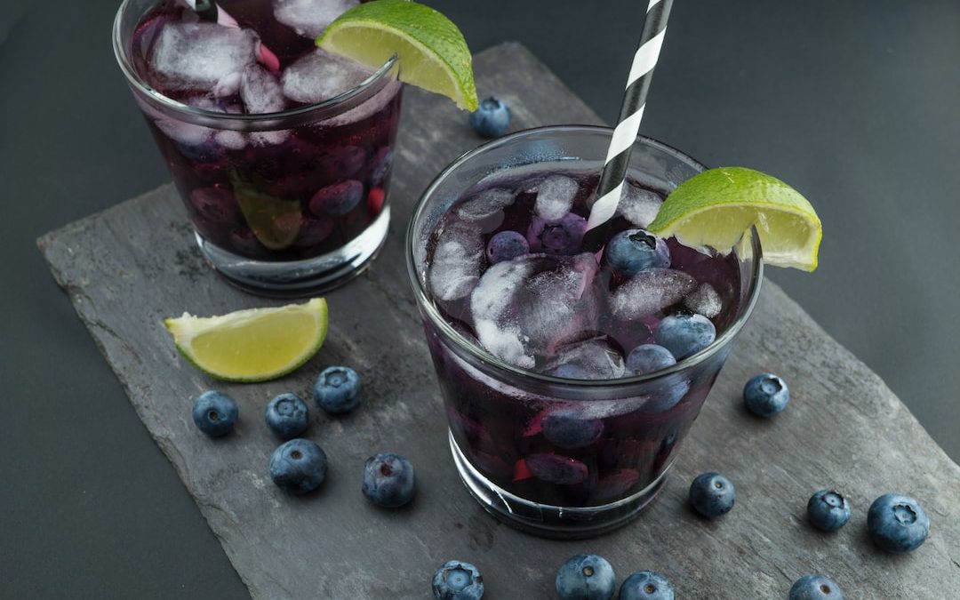 rock glasses surrounded by blackberries