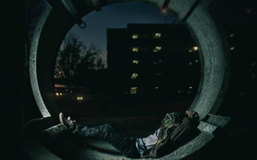 person laying inside hallway with building as background photo