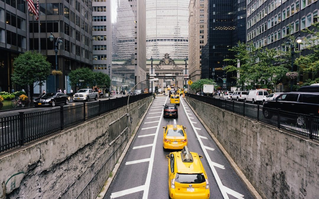 vehicles on road near buildings