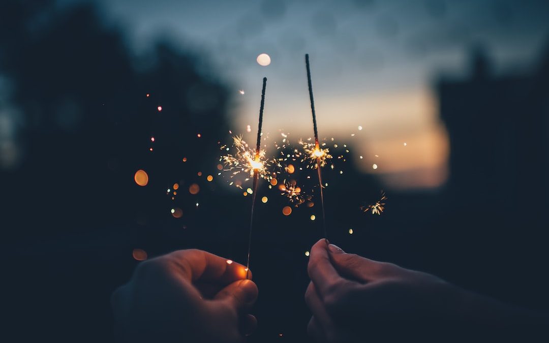 person holding fire cracker shallow focus photography