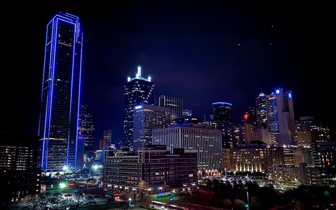 aerial photography of city with high-rise buildings during night time