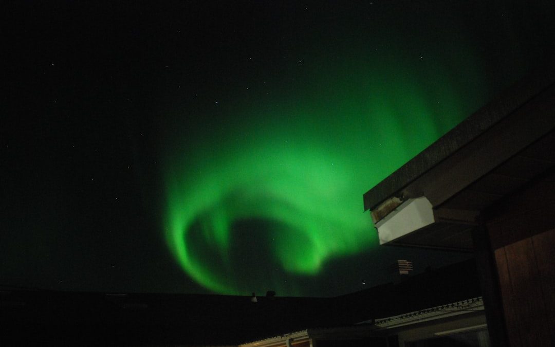 a bright green aurora bore in the night sky