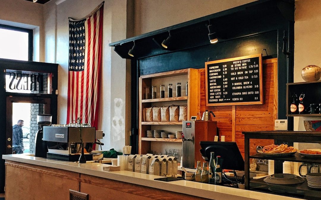 flag of U.S. America hanging on white painted concrete wall