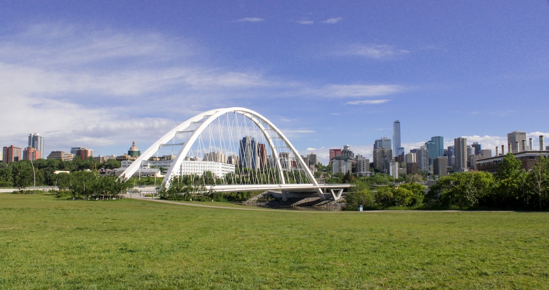 a large glass building with a city in the background