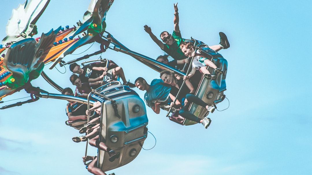 people riding amusement ride during daytime