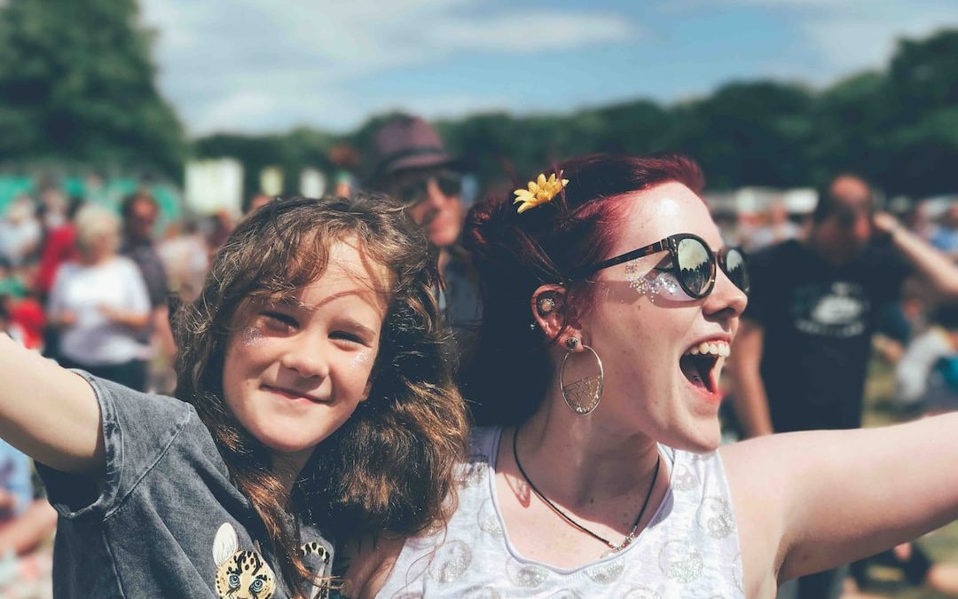 girl and woman near people at the field during day