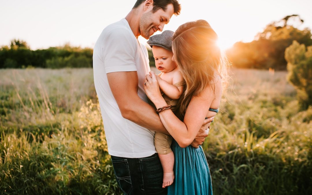 family photo on green grass during golden hour