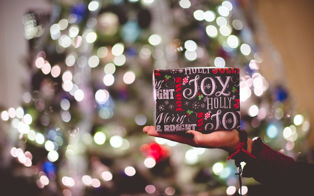 selective focus photography of gift box on person's palm