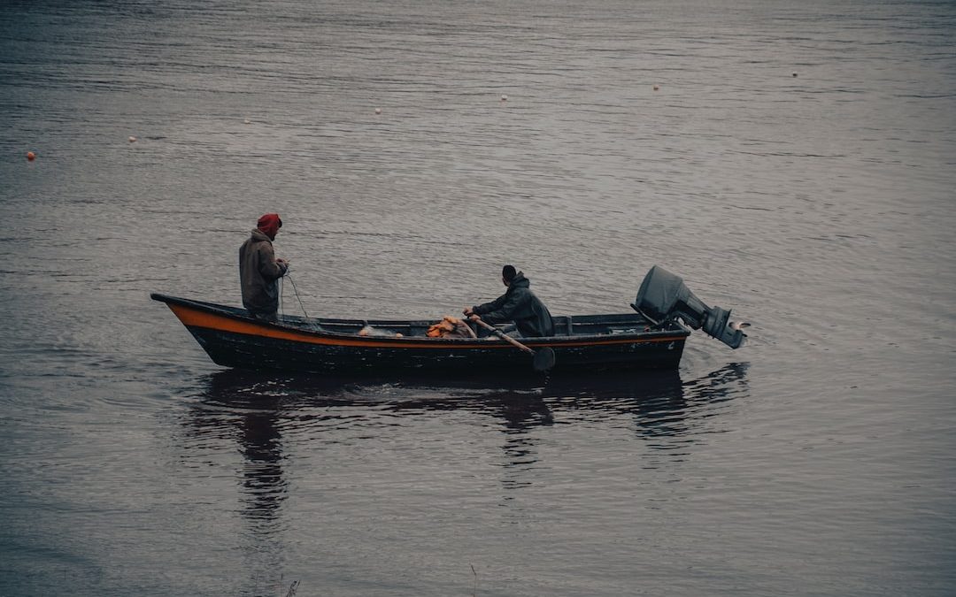 a man in a boat on a body of water