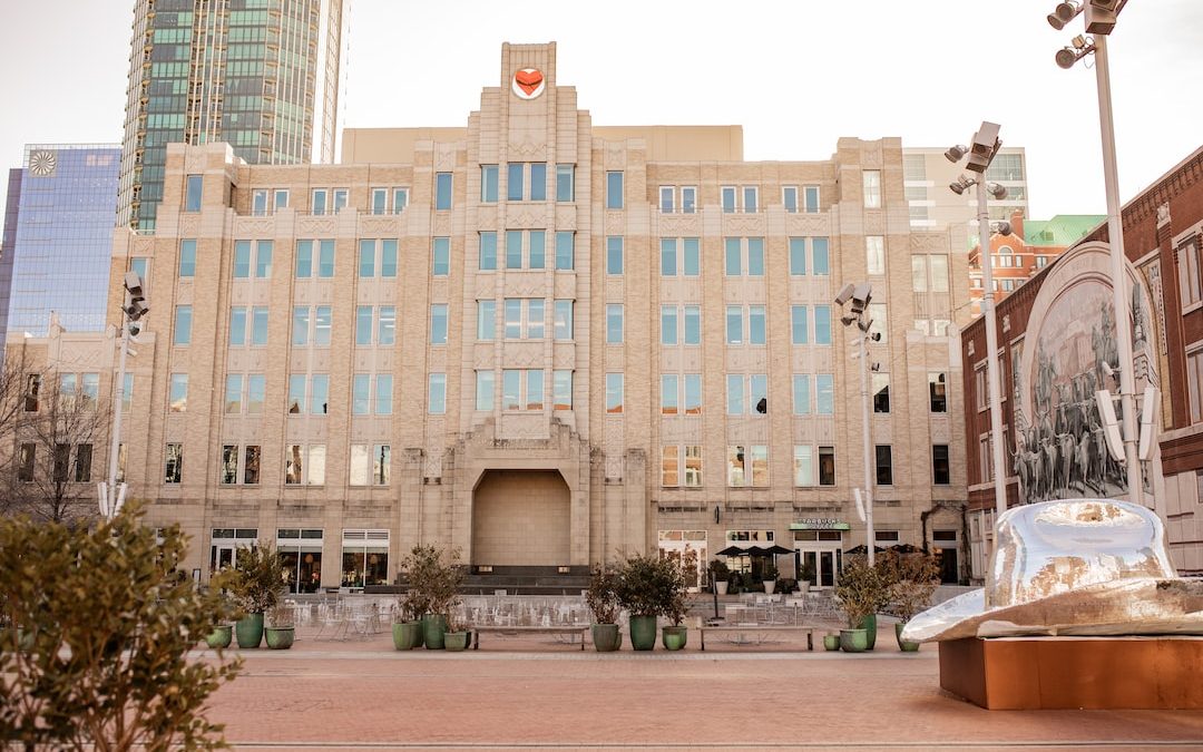 a large building with many windows and a statue in front of it