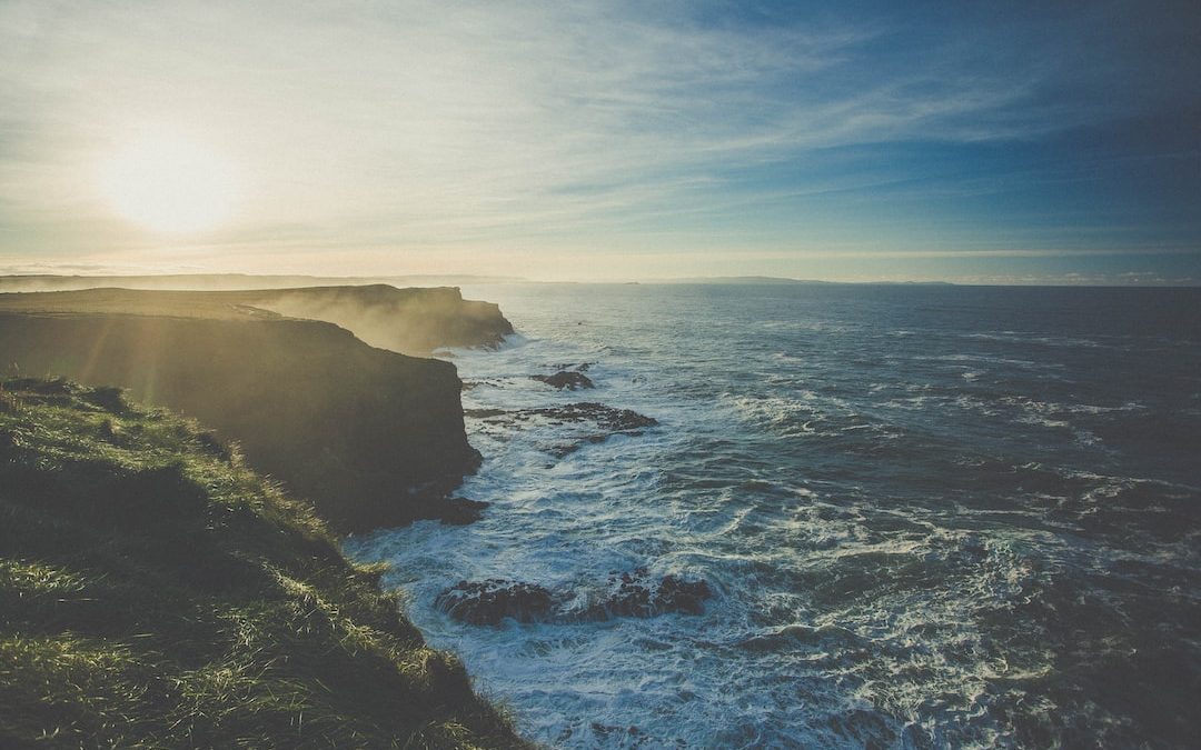 rock cliffs facing rippling body of water