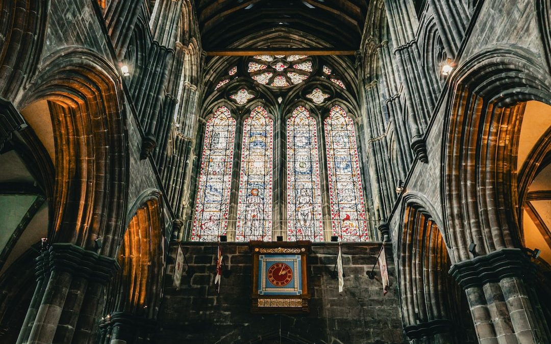 the interior of a cathedral with stained glass windows