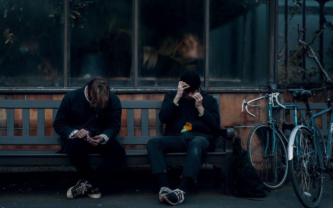 2 women sitting on bench