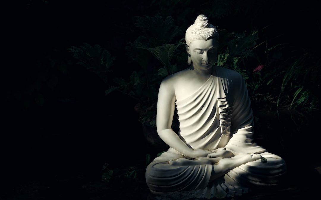 white Buddha statue on body of water