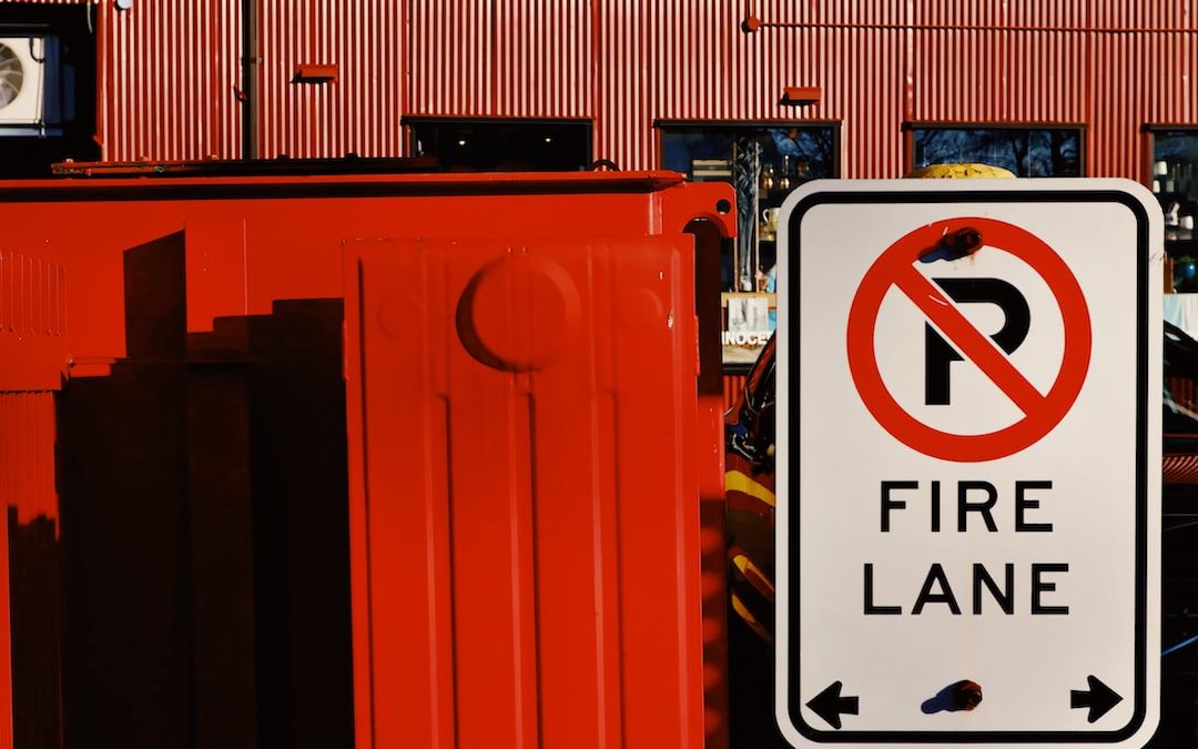 a no parking fire lane sign in front of a red building