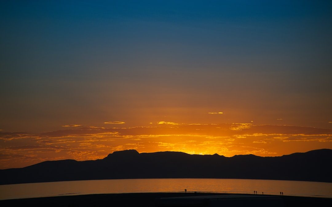 mountain under orange sky during sunset