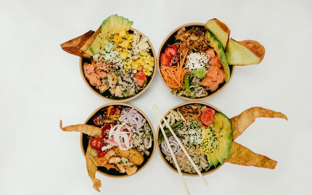 assorted cooked foods in four bowls