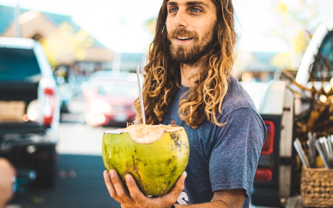 man holding coconut fruit