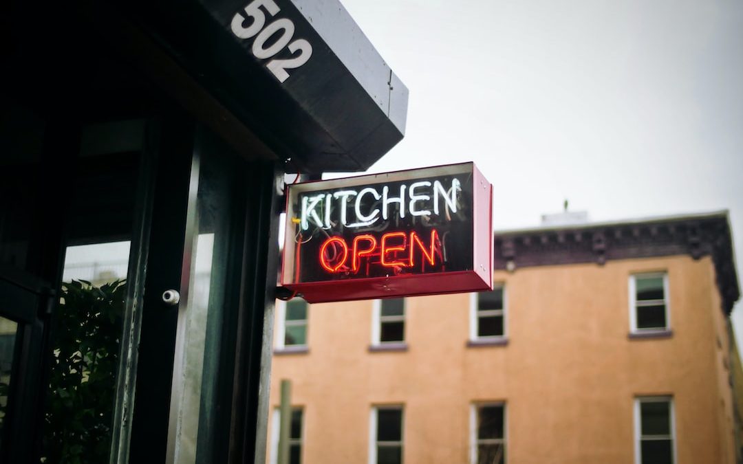 white and red neon lighted kitchen open signage during daytime