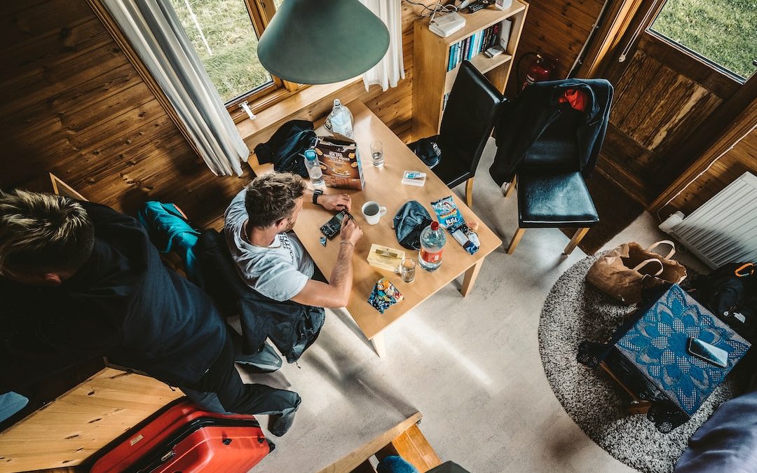 a group of people sitting around a wooden table