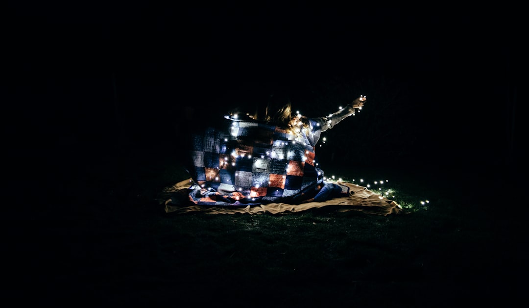 a blanket covered in lights in the dark