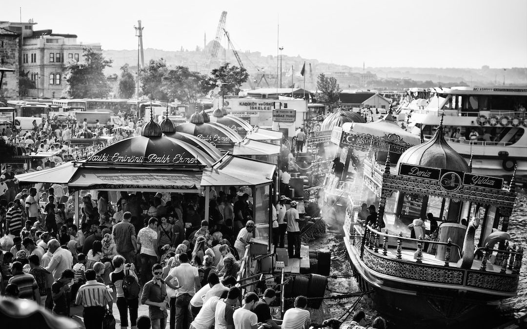 grayscale photo of people riding boats