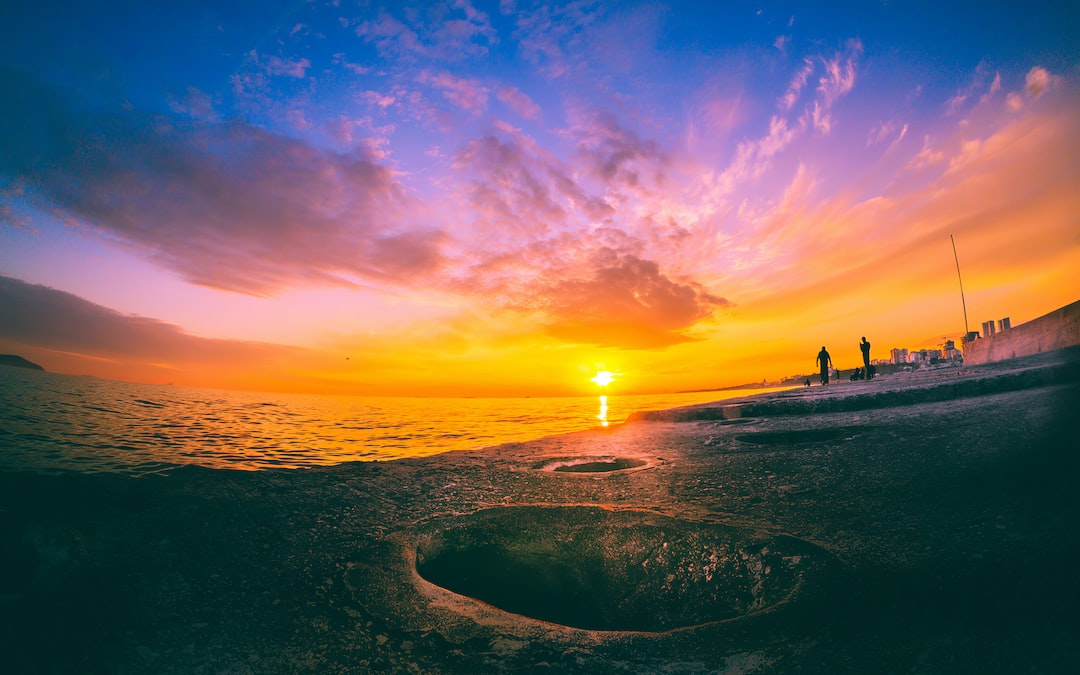 body of water during sunset