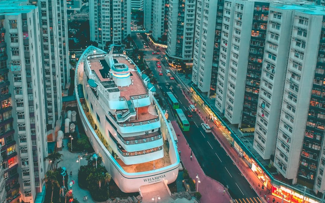 white boat building surrounded with high-rise buildings