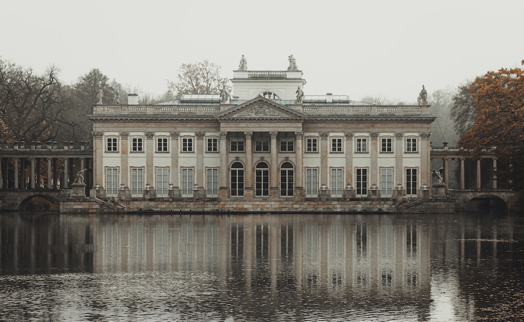 white and brown concrete building near body of water during daytime