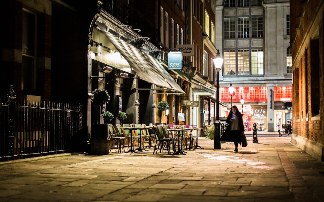 woman walking in alley near white store