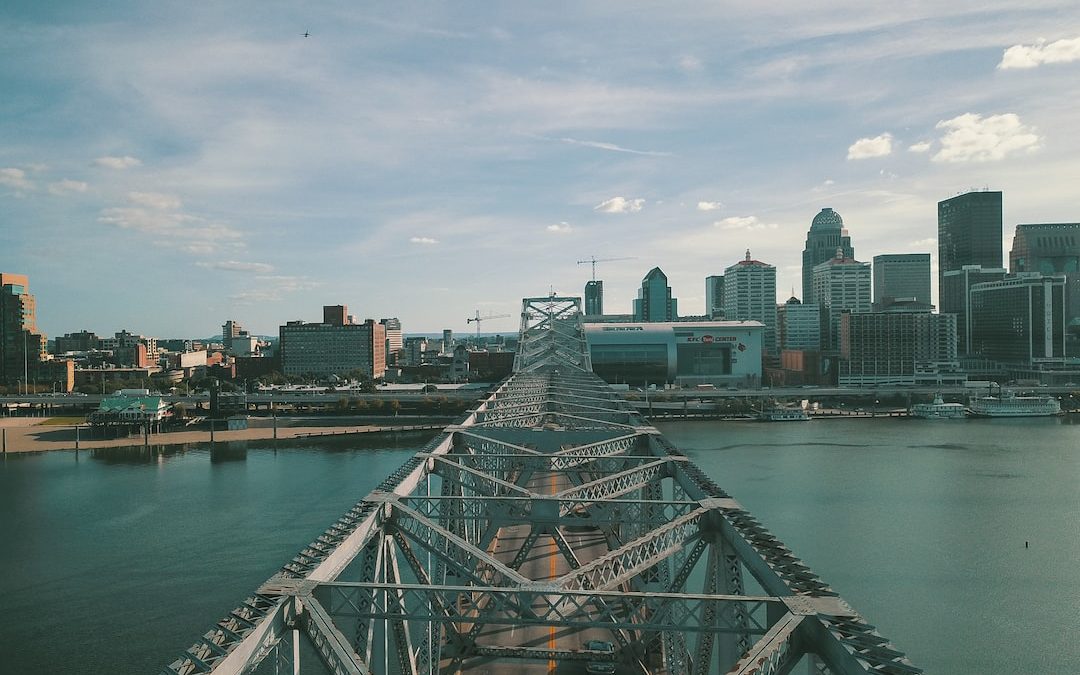 gray concrete bridge above body of water at daytime