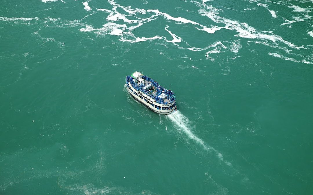 white and blue boat on sea during daytime
