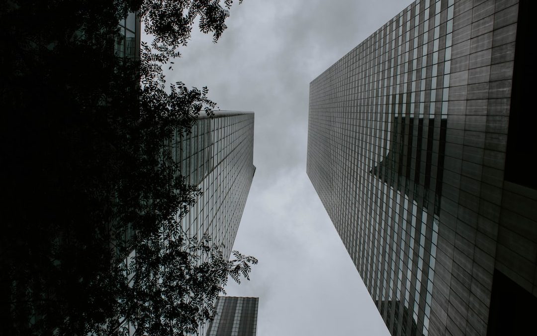 a couple of tall buildings sitting next to each other