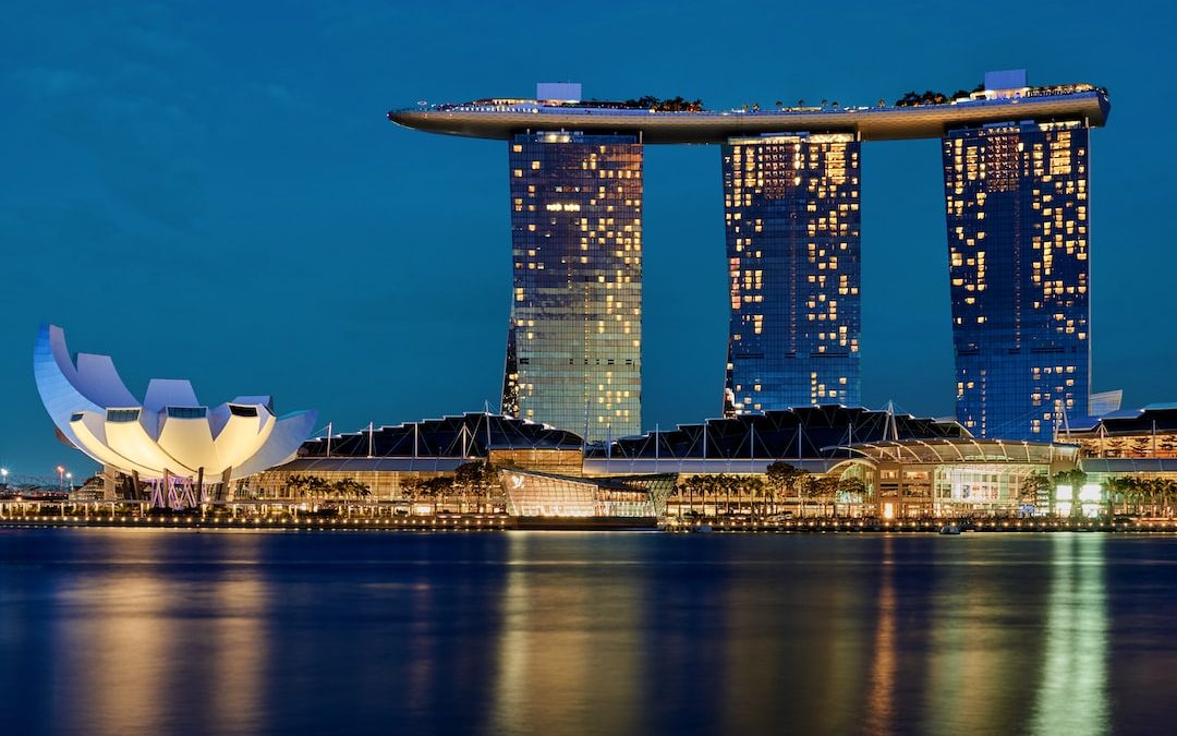 white and blue building near body of water during daytime