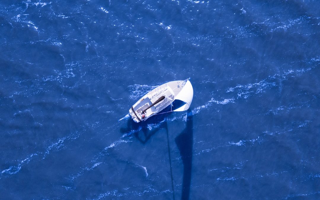 aerial view of boat sailing on blue ocean