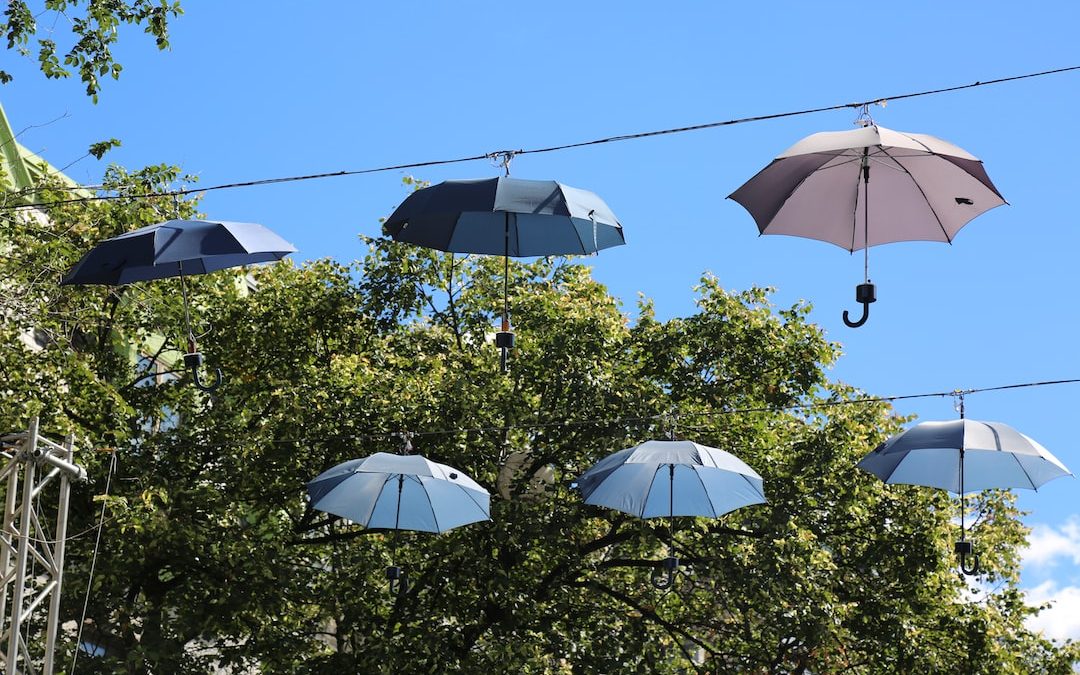 a bunch of umbrellas hanging from a wire