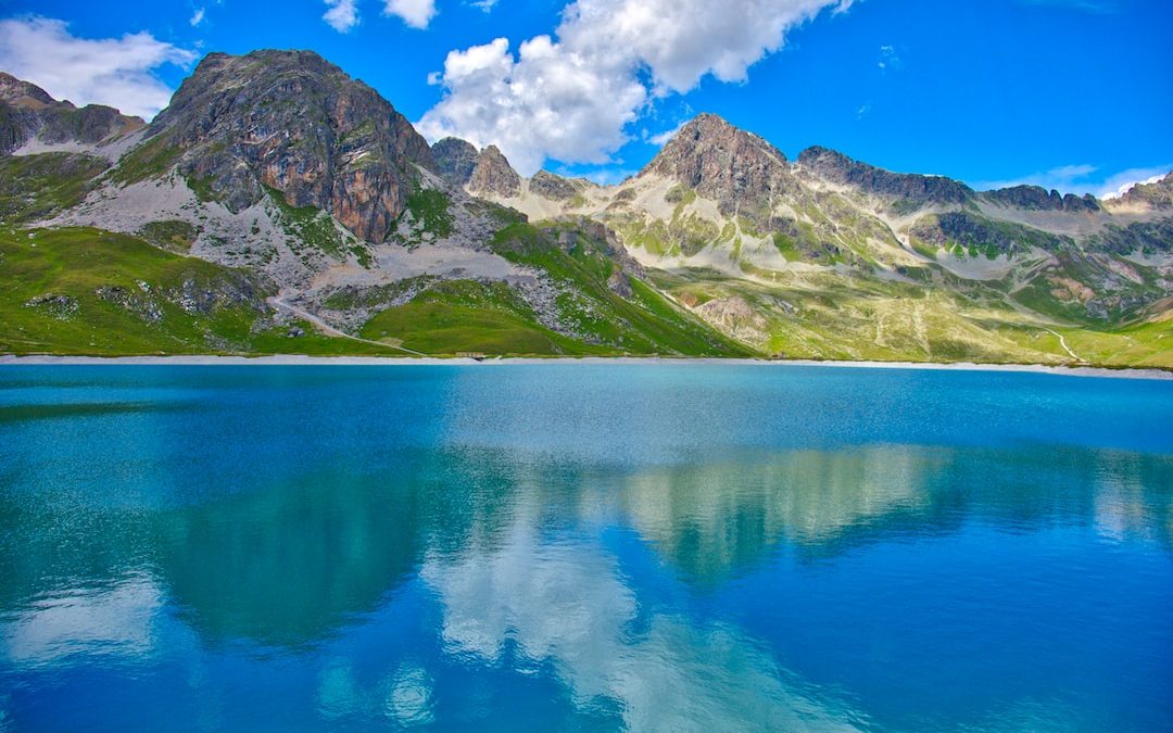 landscape photography of body of water near mountains